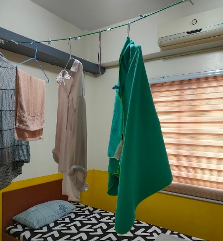 Laundry drying on a clothesline in a dormitory room