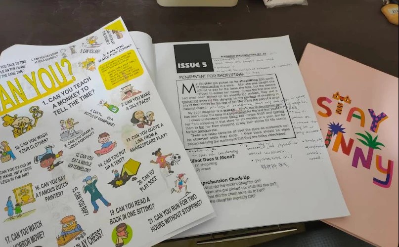 English class handouts covered in handwritten notes